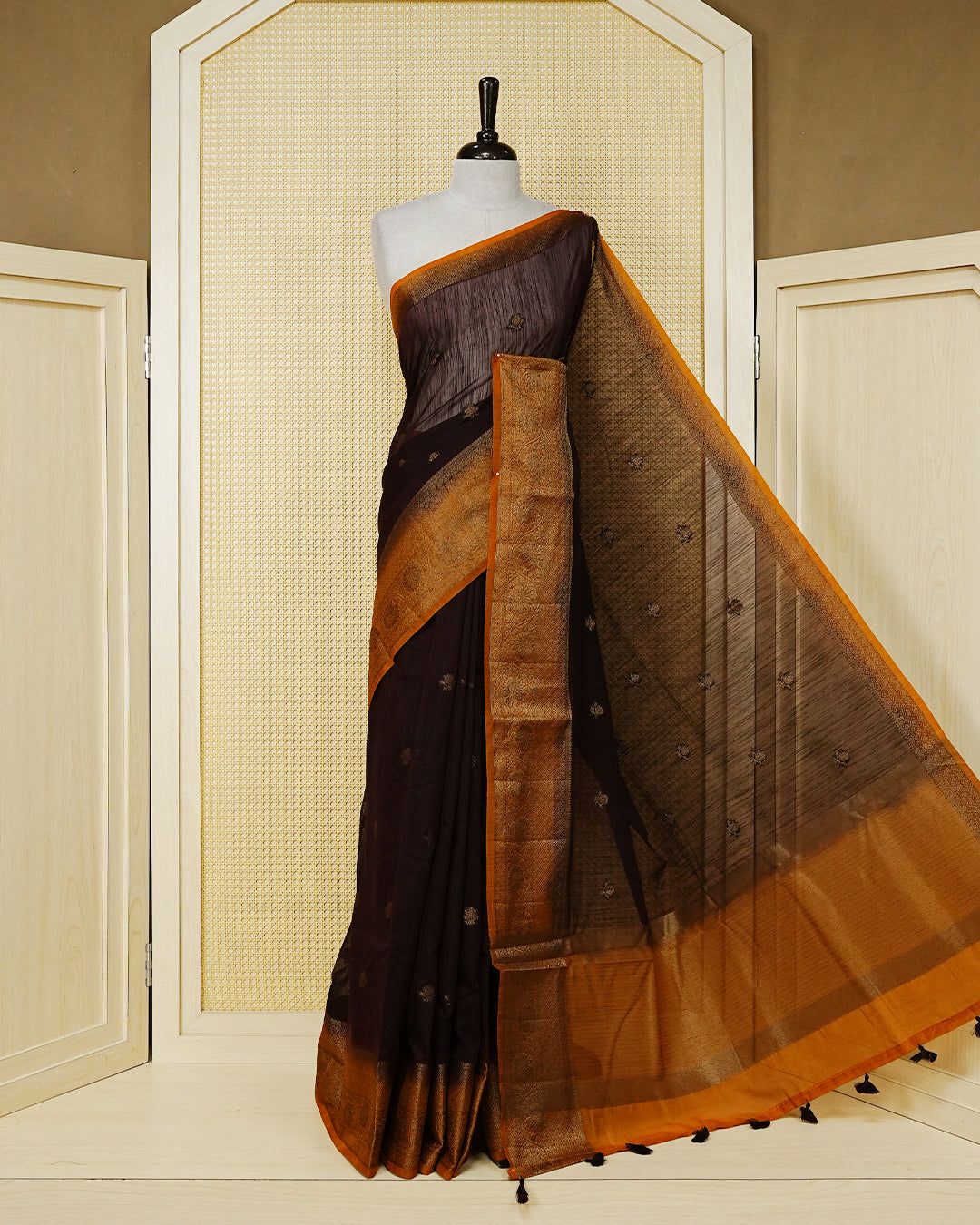 Dark brown colour semi linen saree thread motifs on body, contrast mustard orange colour gold zari border, rich pallu comes with matching blouse piece