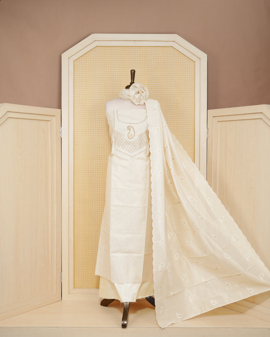 Cream colour tissue salwar material featuring elegant floral embroidery pattern adorned with Mirror and beadswork on Top, paired with matching bottom and elegant dupatta.