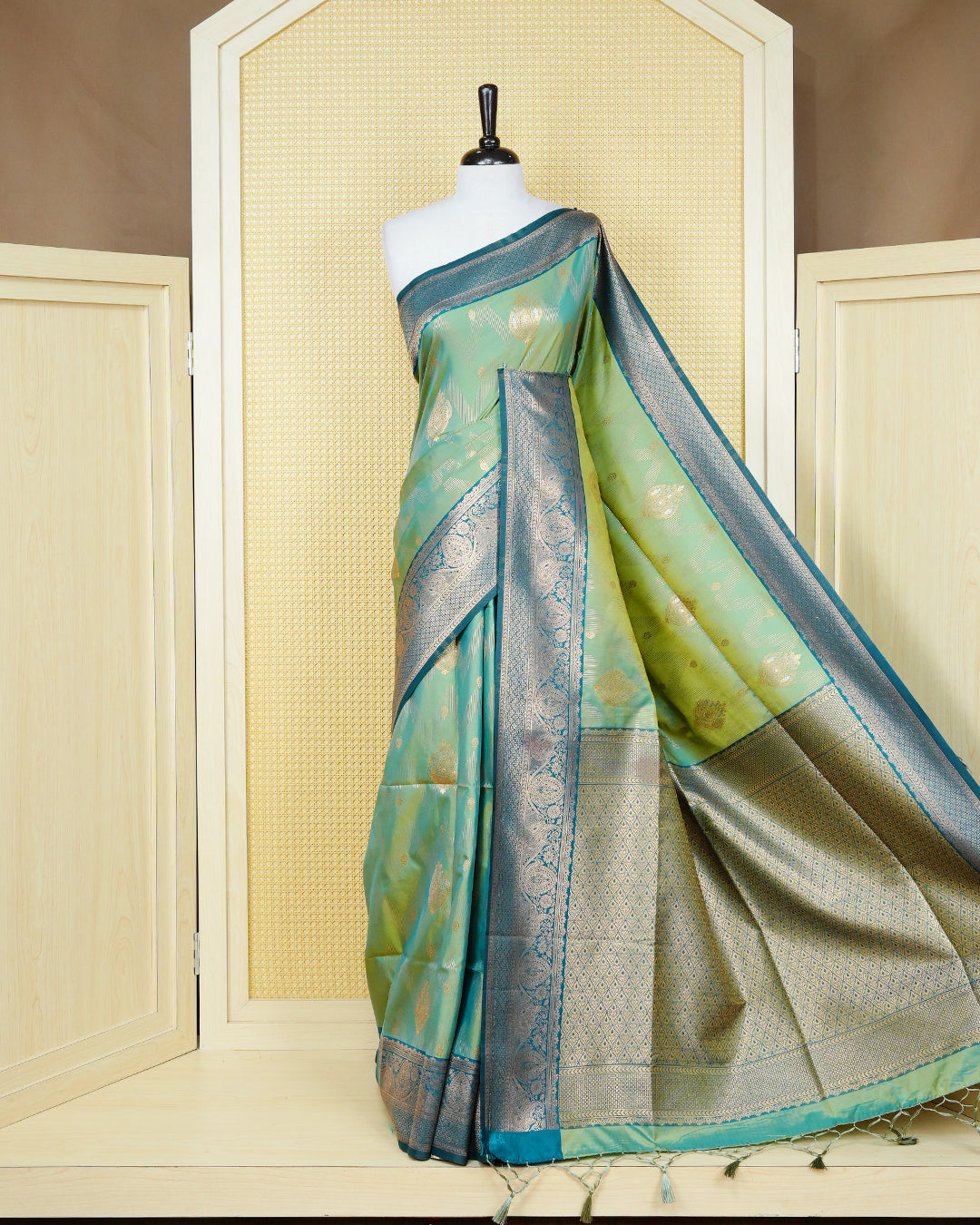 Green & gold double shade Mulberry silk saree featuring gold zari patterns on body , paired with contrast teal colour with traditional border, comes with matching blouse piece.
