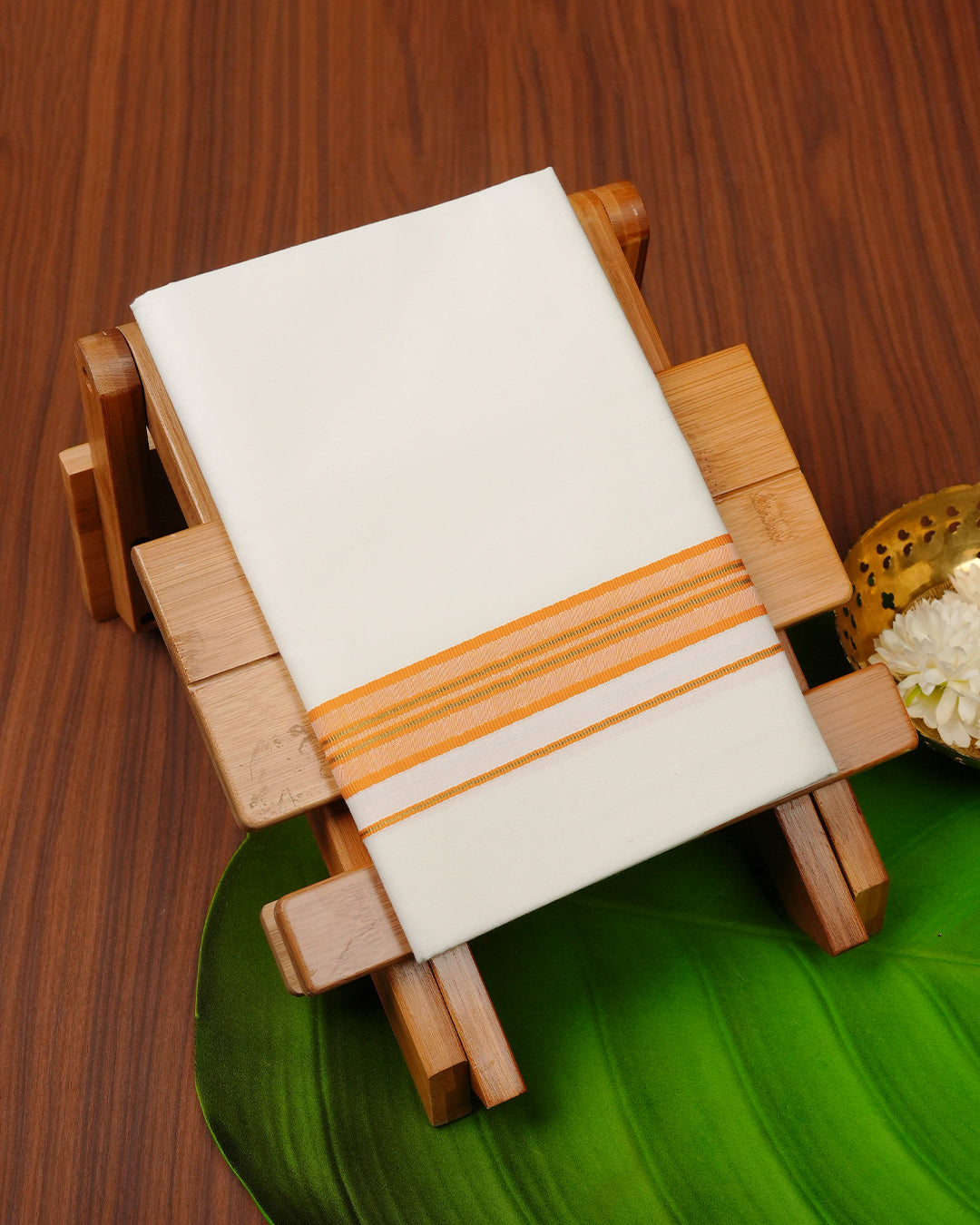 Cream colour cotton Single dhoti featuring Orange & gold border.