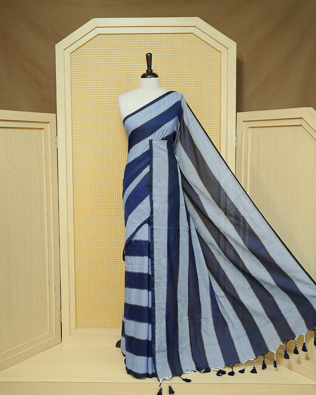 Navy Blue & Light Blue colour Mul cotton saree featuring Gold zari strips, complemented by self colour simple Border & tassels.