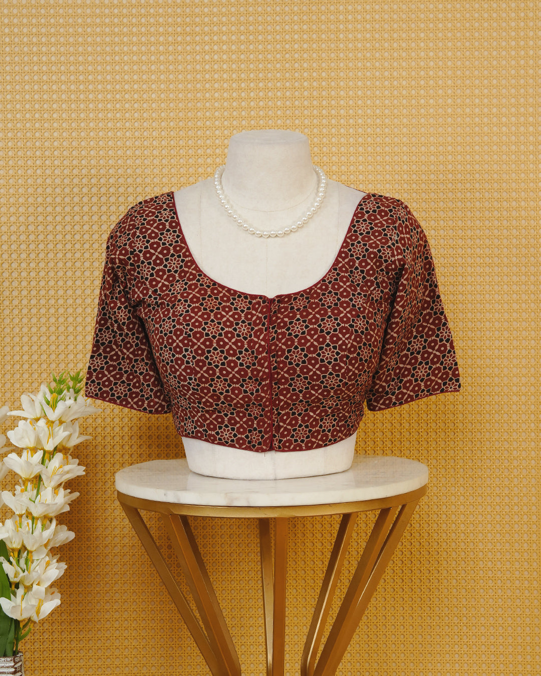 Maroon Colour Blouse Featuring A Classic U-Neck, Intricate Floral Geometric Print, And Comfortable Elbow Length Sleeves.