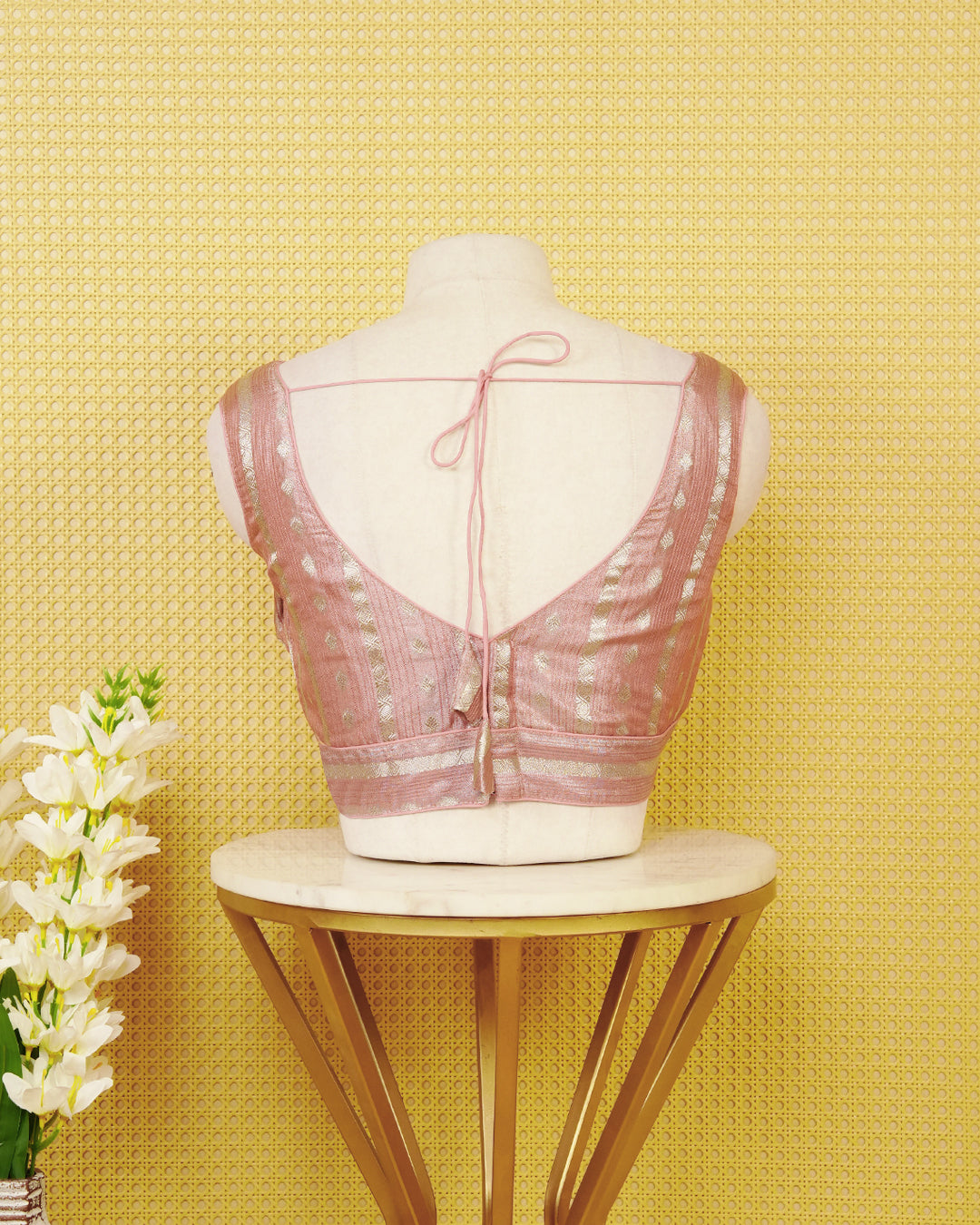 Baby pink colour Sleeveless Blouse Featuring A Stylish V-Neck, Elegant Woven Zari Stripes With Butta Motifs, And A Comfortable Tailored Fit.