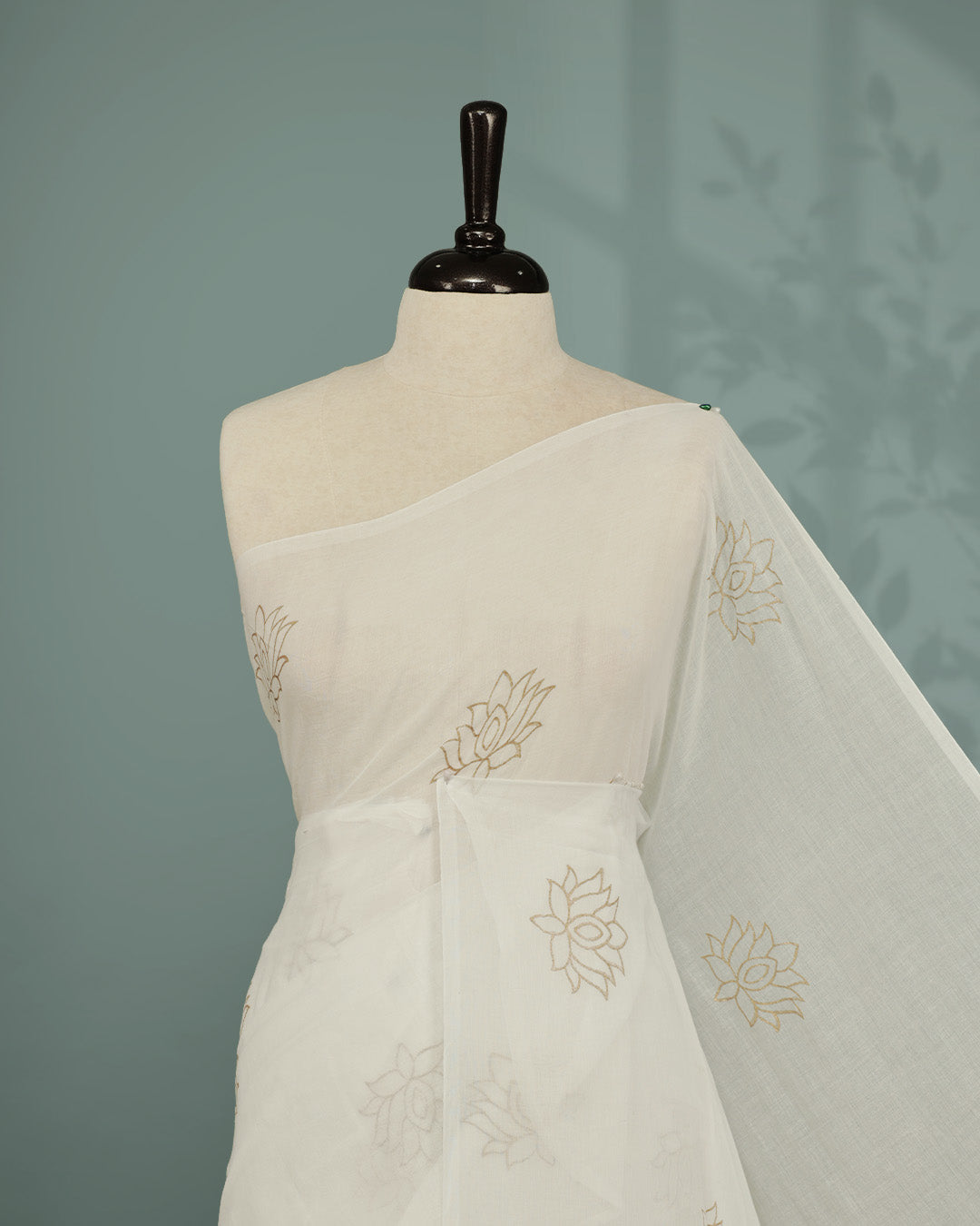 White colour pure mul cotton saree featuring Minimal Lotus Print on body, Clean Borderless design, elegant tassels.