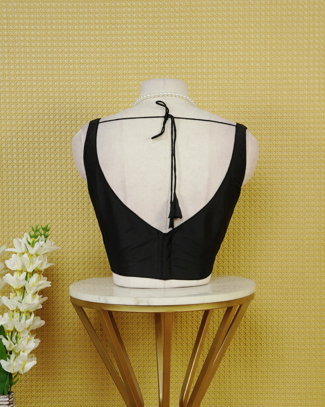 Black Colour Plain Blouse Featuring A Simple Boat Neckline, Sleeveless Design, And A Clean Fitted Silhouette.