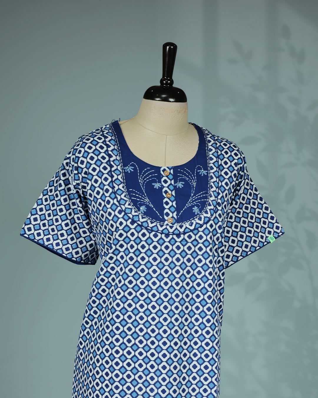 Blue and white geometric printed nighty with a classic soft square neckline, short sleeves, an embroidered contrast yoke with wooden button detailing, and a relaxed full-length for everyday comfort and timeless style.