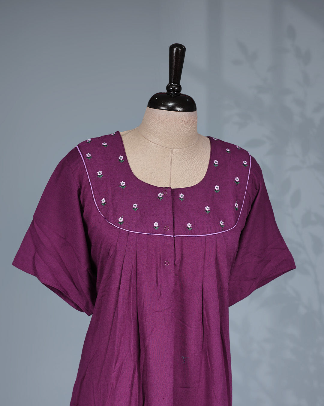 Dark Plum solid nighty featuring a floral embroidered yoke with contrast piping, a round neckline & short sleeves and a relaxed full-length for all-day comfort and timeless style.
