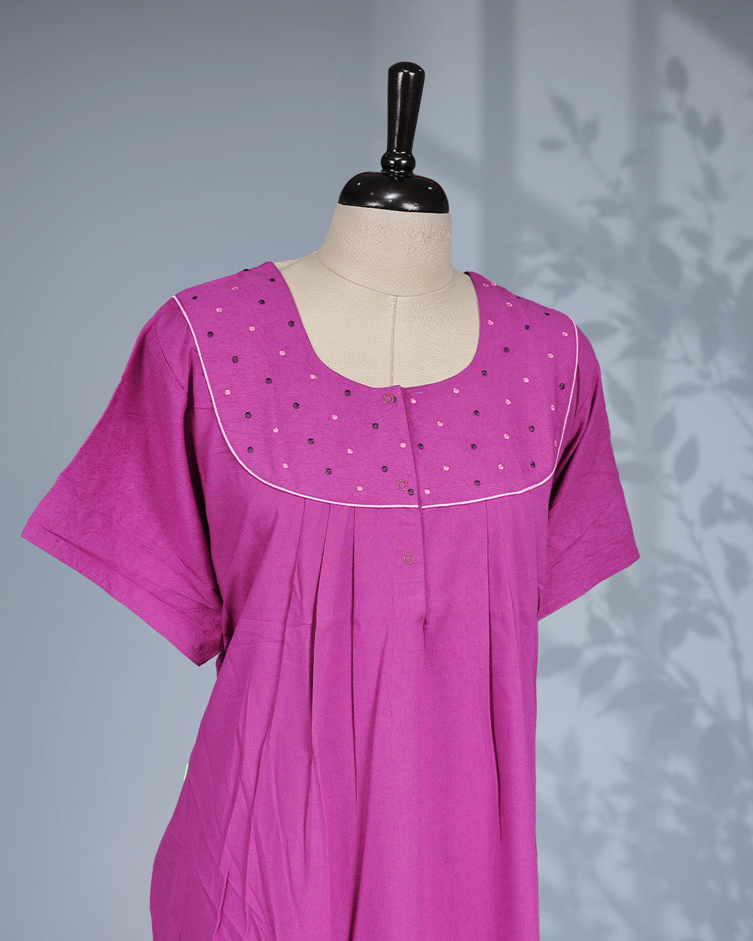 Purple colour nighty featuring a Tread work on yoke, an openable button-front Round neckline design, short sleeves & an ankle-length fit.