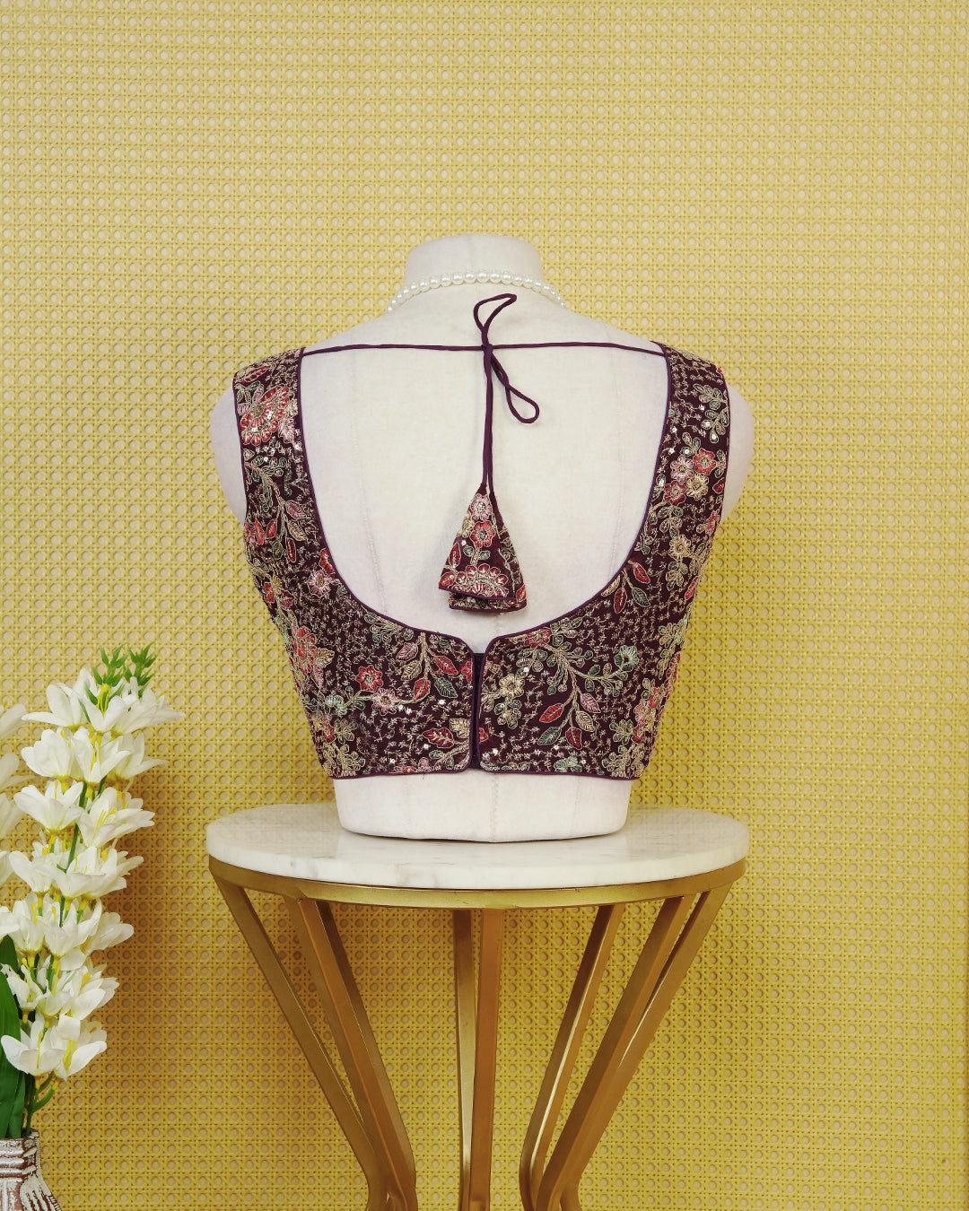 Purple colour Embroidered Sleeveless Blouse Featuring A Stylish V-Neck, Intricate Floral Embroidery With Sequin Detailing, And A Comfortable Tailored Fit.