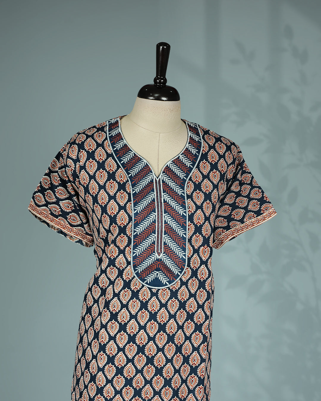 Navy blue and rust paisley printed nighty with a split V-neckline, short sleeves, a thread worked yoke with intricate leaf motifs, and a relaxed full-length for everyday comfort and effortless style.