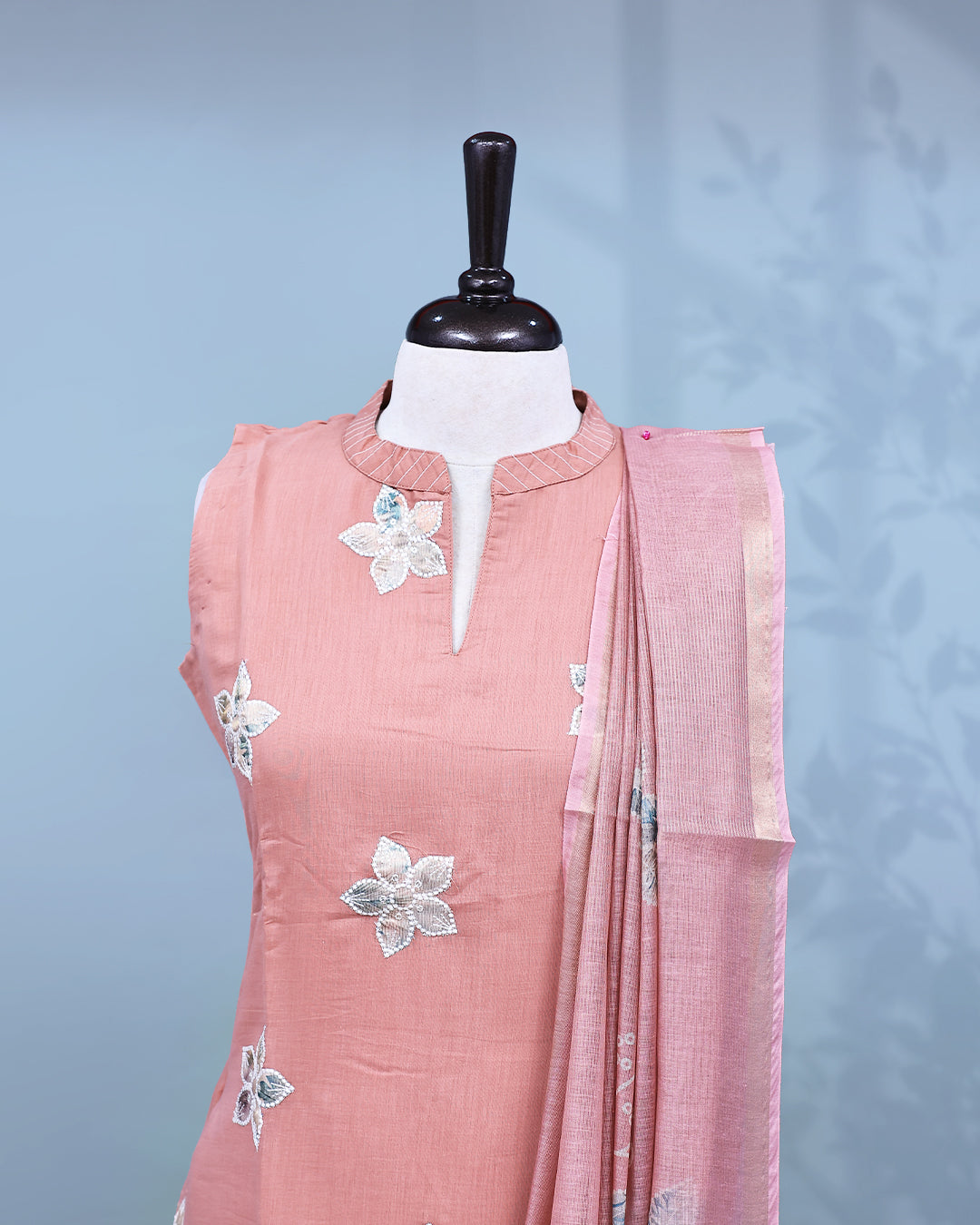 Pastel Peach colour Salwar set comes top with floral pattern on body, paired with matching bottom and dupatta.