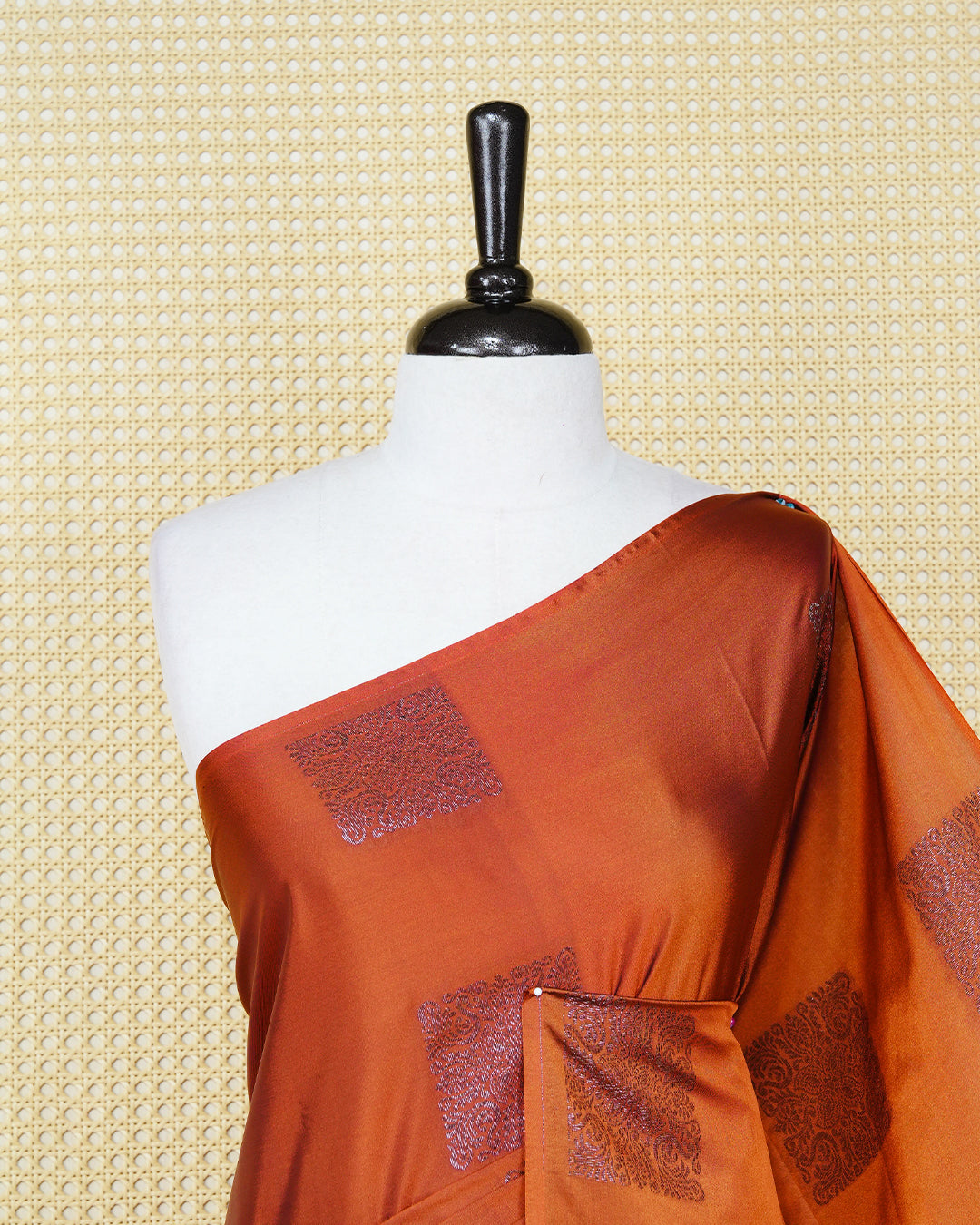 Burnt orange colour soft silk saree featuring antique zari motifs on body with contrast dark purple colour pallu & paired with matching blouse piece.