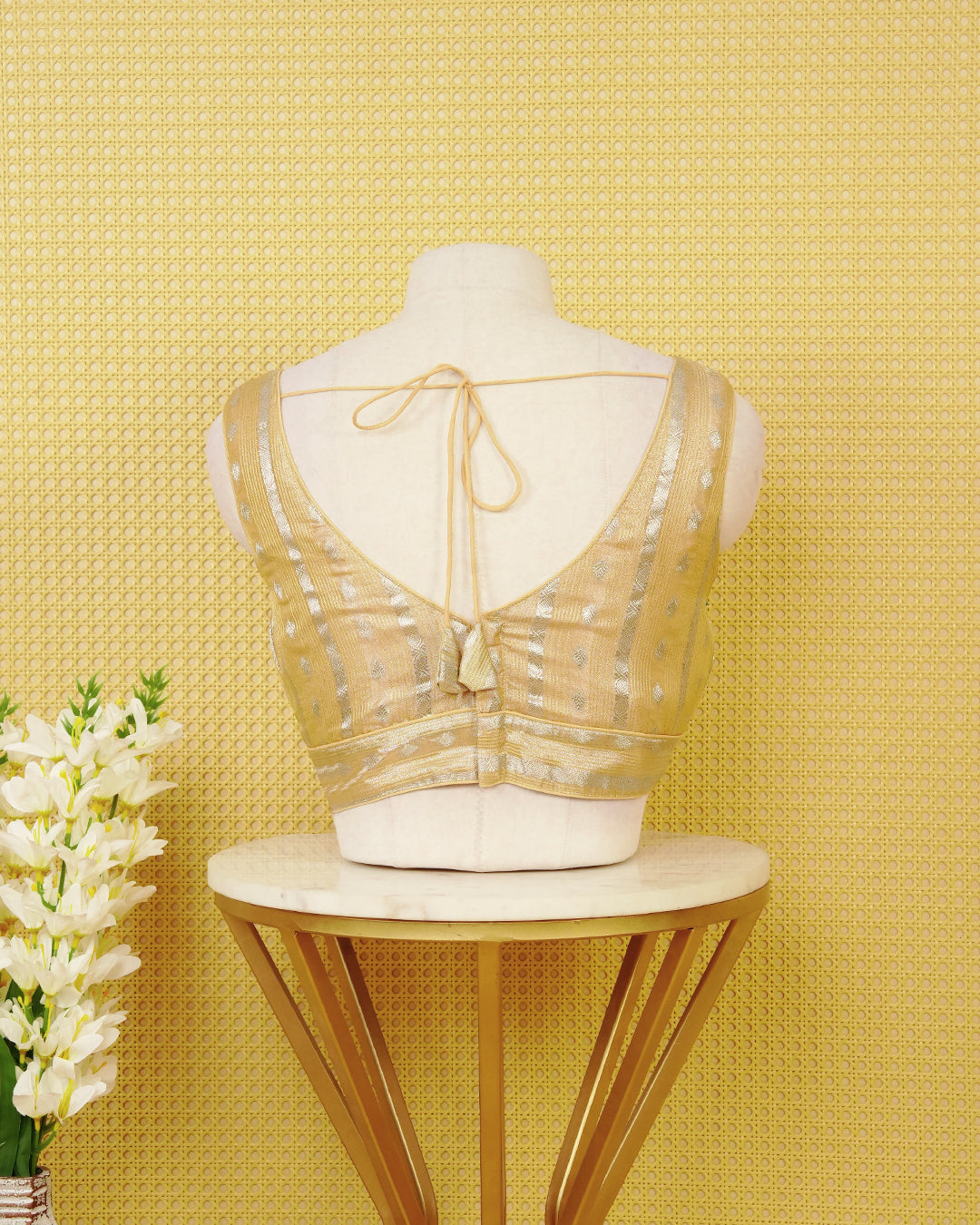 Pale Yellow colour Sleeveless Blouse Featuring A Stylish V-Neck, Elegant Woven Zari Stripes With Butta Motifs, And A Comfortable Tailored Fit.