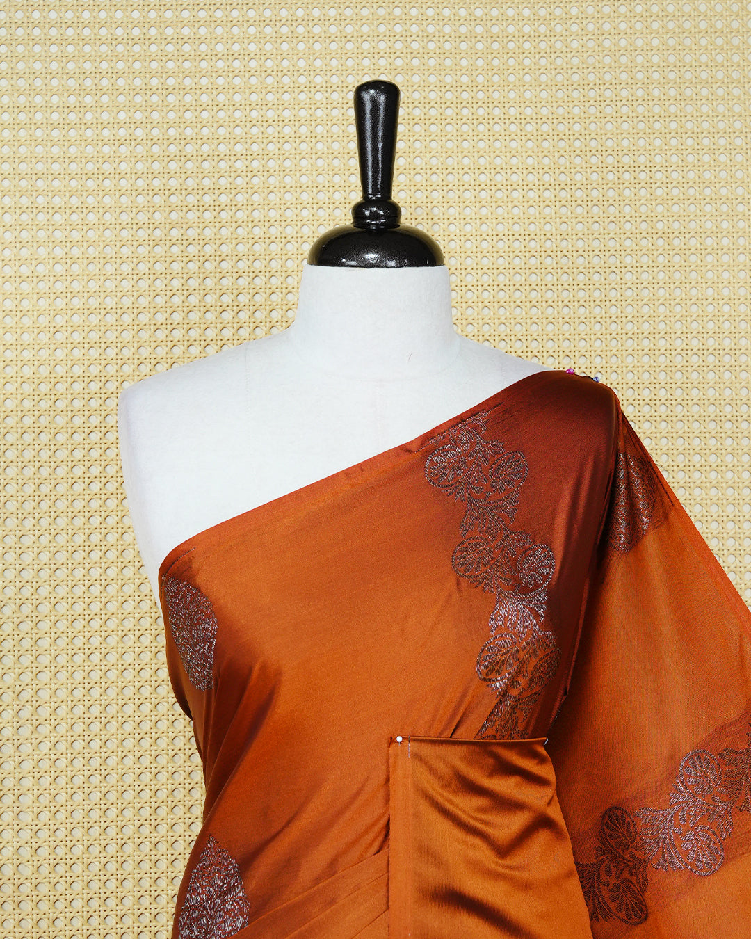 Rust orange colour soft silk saree featuring antique zari motifs on body with contrast self colour pallu & paired with matching blouse piece.