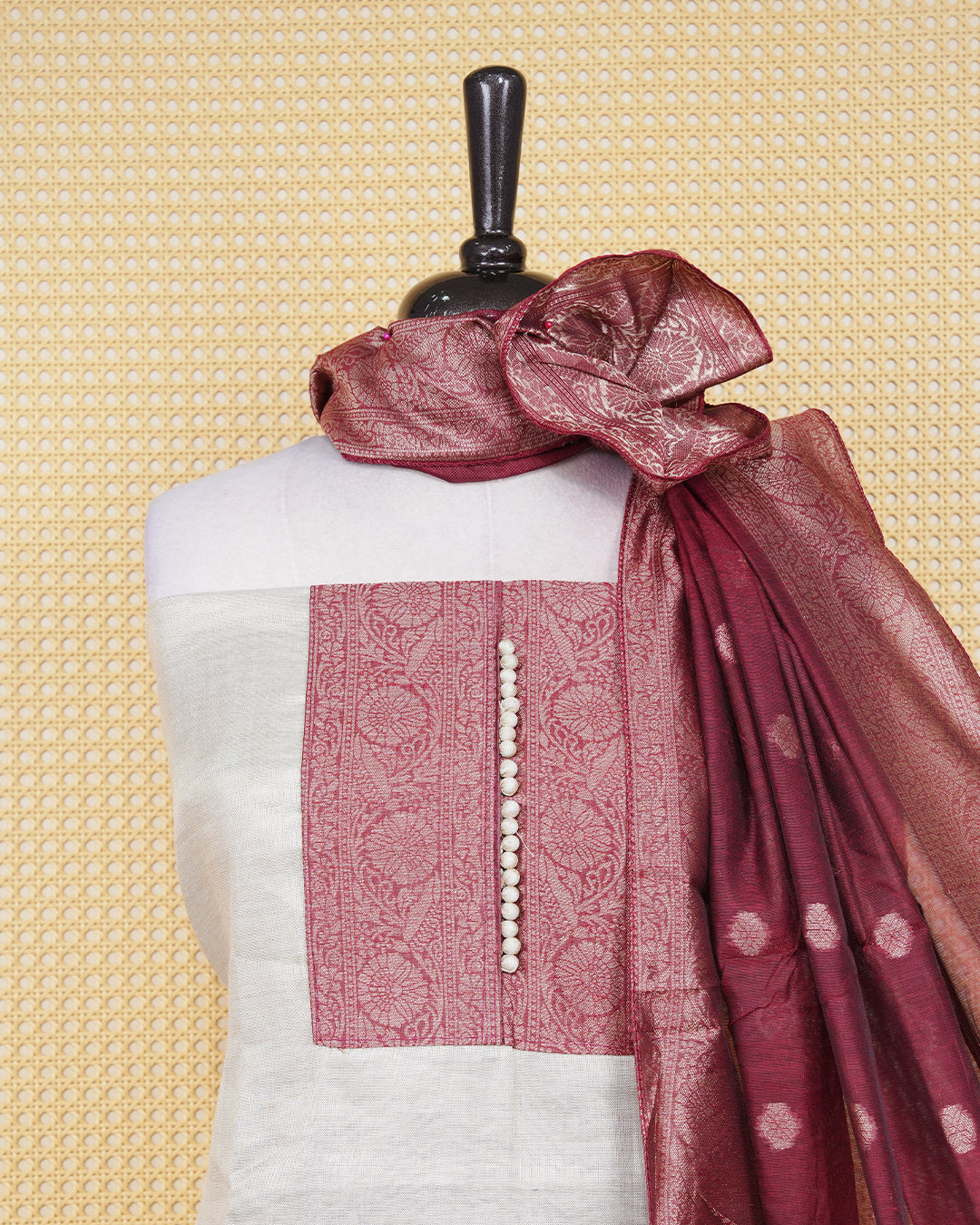 Cream colour salwar material featuring Plain Body Design without border, Maroon colour work on neck portion, paired with matching bottom and elegant dupatta.
