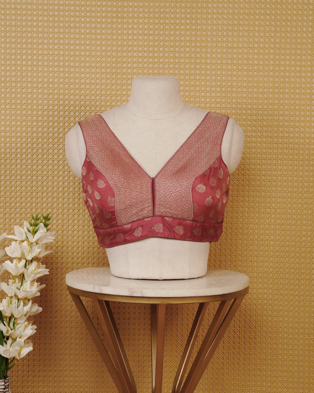 Mauve colour Sleeveless Blouse Featuring A Stylish V-Neck, Elegant Woven Pattern With Gold Butta Motifs, And A Comfortable Tailored Fit.