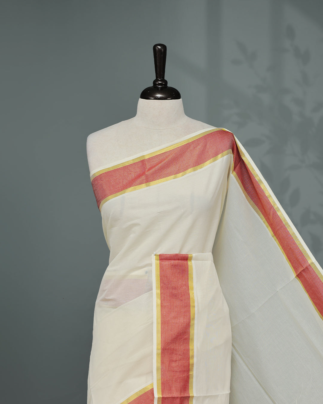 Cream colour Kerala saree Featuring an Elegant plain body, complemented by a classic gold & Red zari border, matching blouse piece.