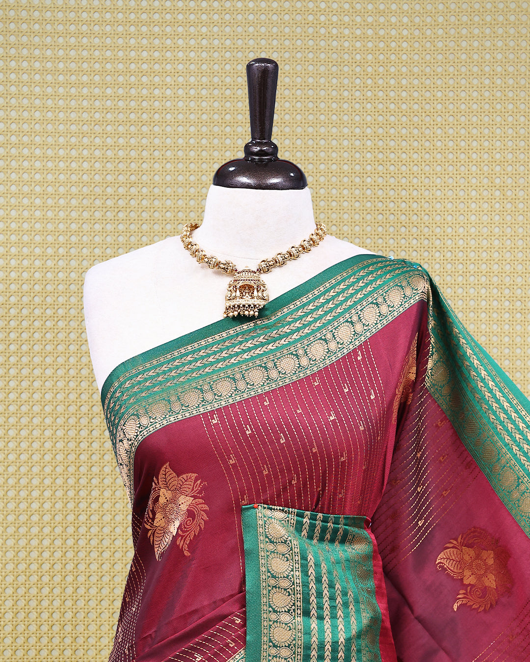 Maroon & gold double shade Mulberry silk saree featuring floral gold zari patterns on body, paired with contrast green colour with traditional border, comes with matching blouse piece.