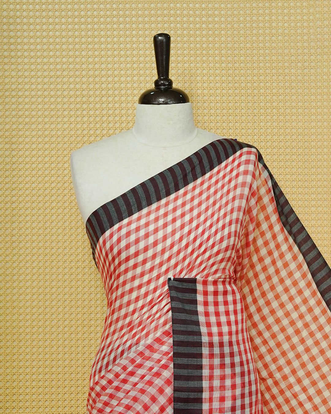Red & Off-White Checked Mul Cotton Saree featuring an elegant all-over checked pattern, complemented by a black striped contrast border and matching black tassels.
