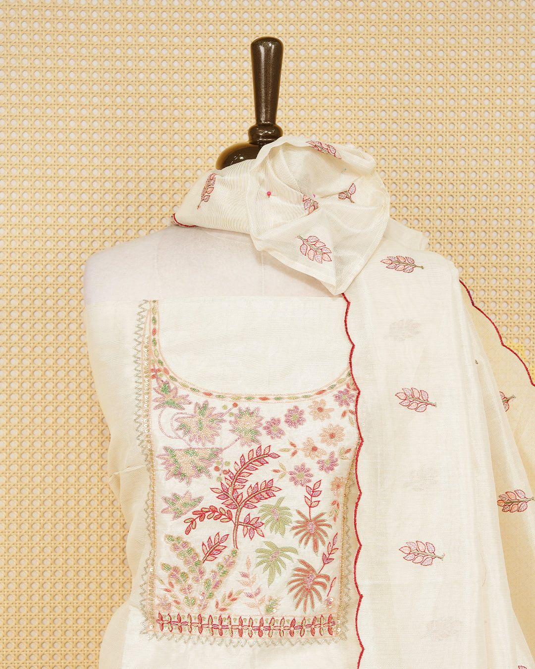 Cream tissue salwar material featuring elegant floral embroidery pattern adorned with beadwork, paired with matching bottom and elegant dupatta.
