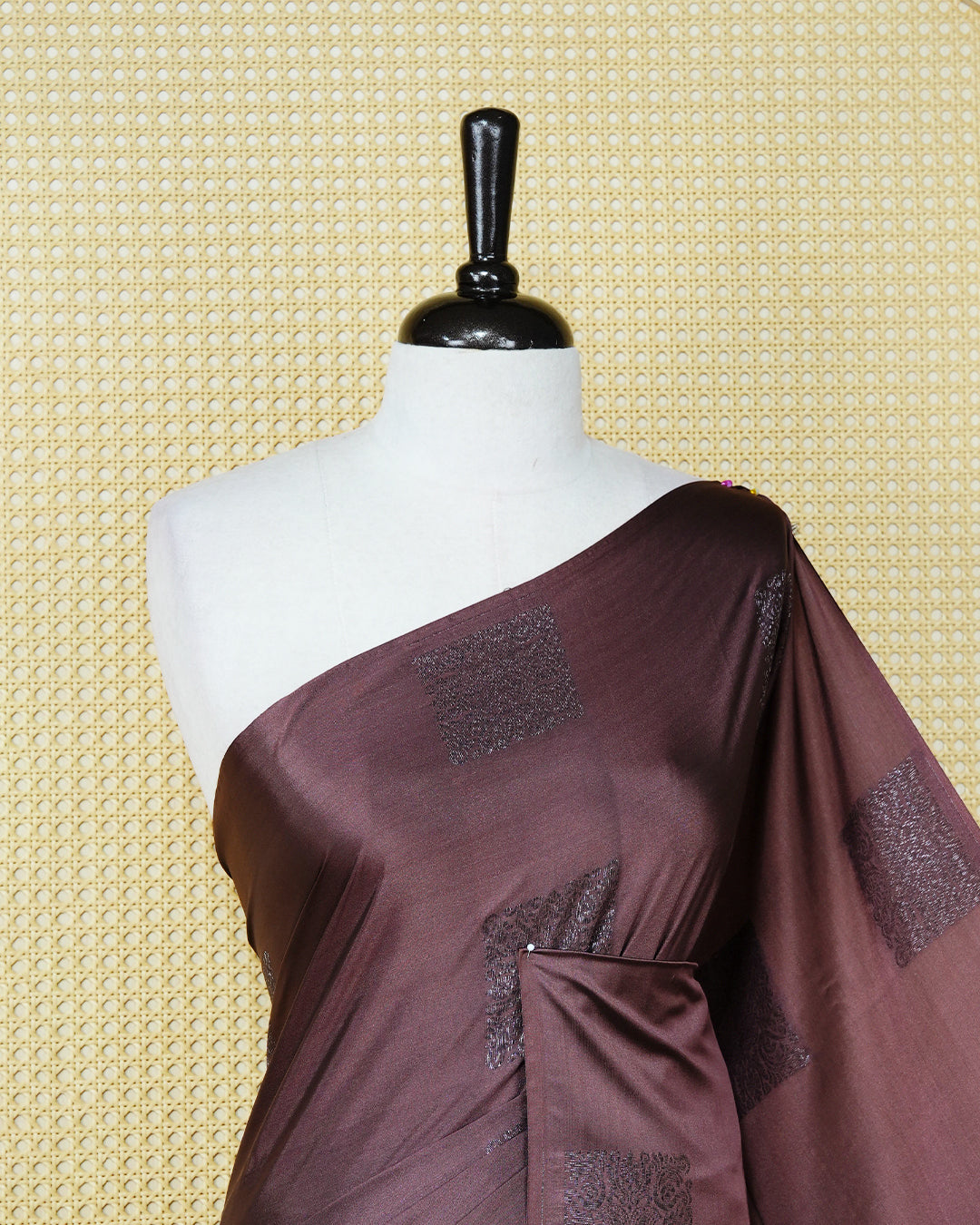 Dark mauve colour soft silk saree featuring antique zari motifs on body with contrast self colour pallu & paired with matching blouse piece.