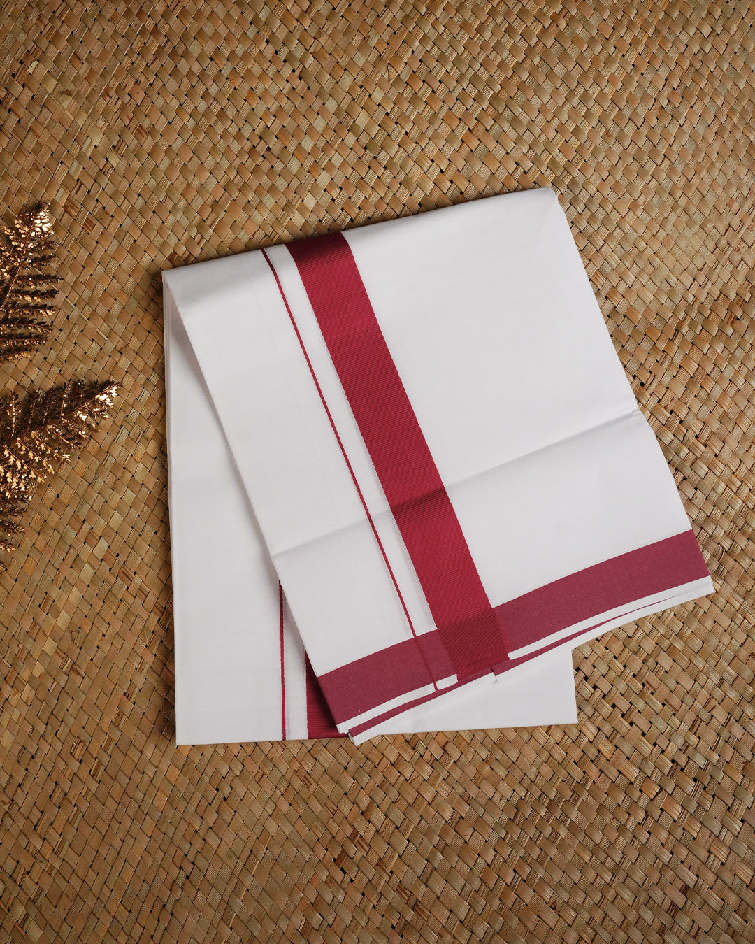 White colour cotton single dhoti featuring Rani Pink border.