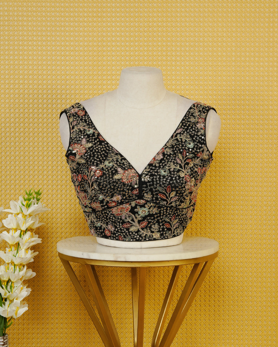 Black colour Embroidered Sleeveless Blouse Featuring A Stylish V-Neck, Intricate Floral Embroidery With Sequin Detailing, And A Comfortable Tailored Fit.