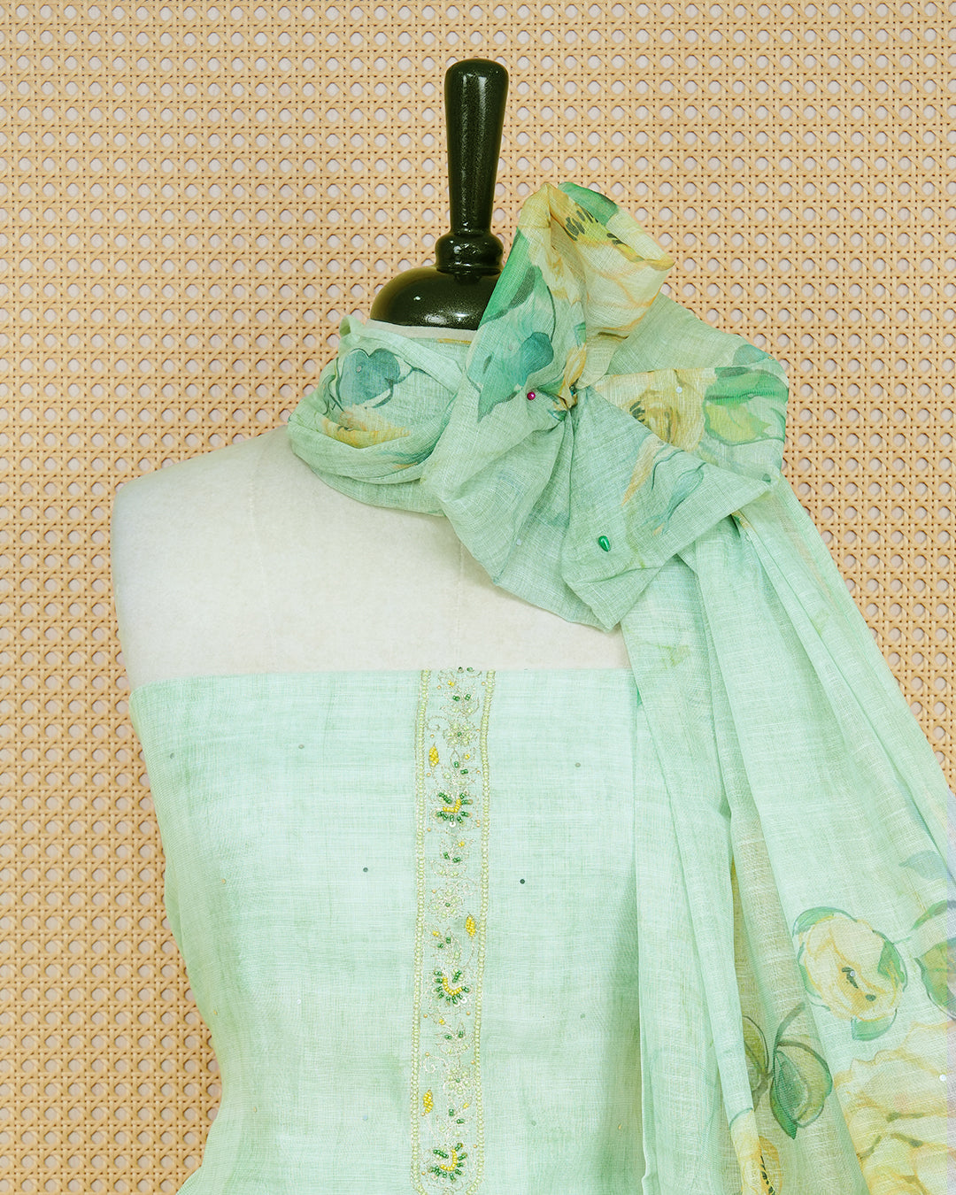 Pastel Green Linen Salwar Material featuring beadwork on the neck yoke, mirror work, and floral prints, paired with a matching bottom and dupatta.
