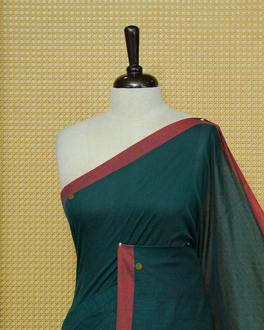 Dark Green Colour Mul Cotton Saree featuring delicate gold sequin detailing on the body, a contrasting maroon border, finished with black tassels.