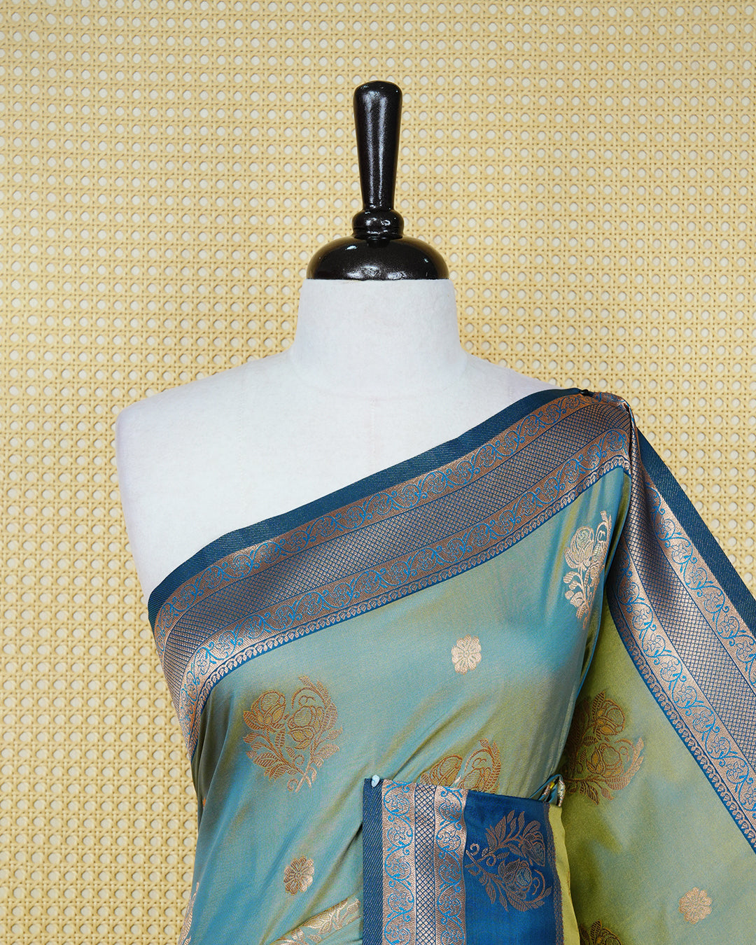 Light green & gold double shade Mulberry silk saree featuring floral gold zari patterns on body, paired with contrast teal colour with traditional border, comes with matching blouse piece.