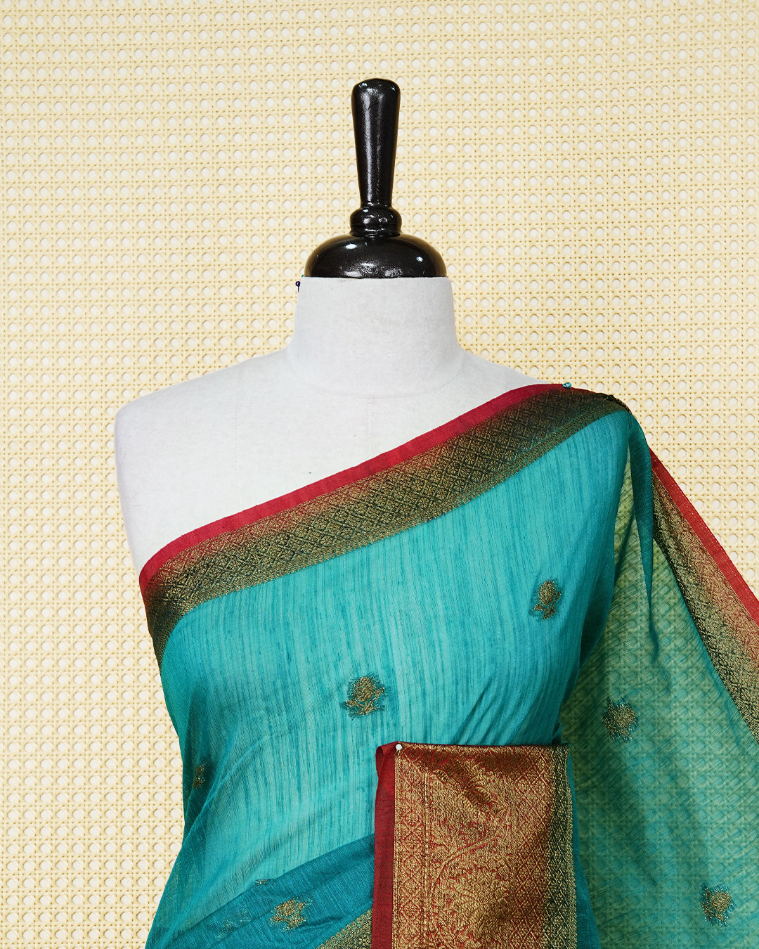 Teal blue colour semi linen saree thread motifs on body, contrast green colour gold zari border, rich pallu comes with matching blouse piece