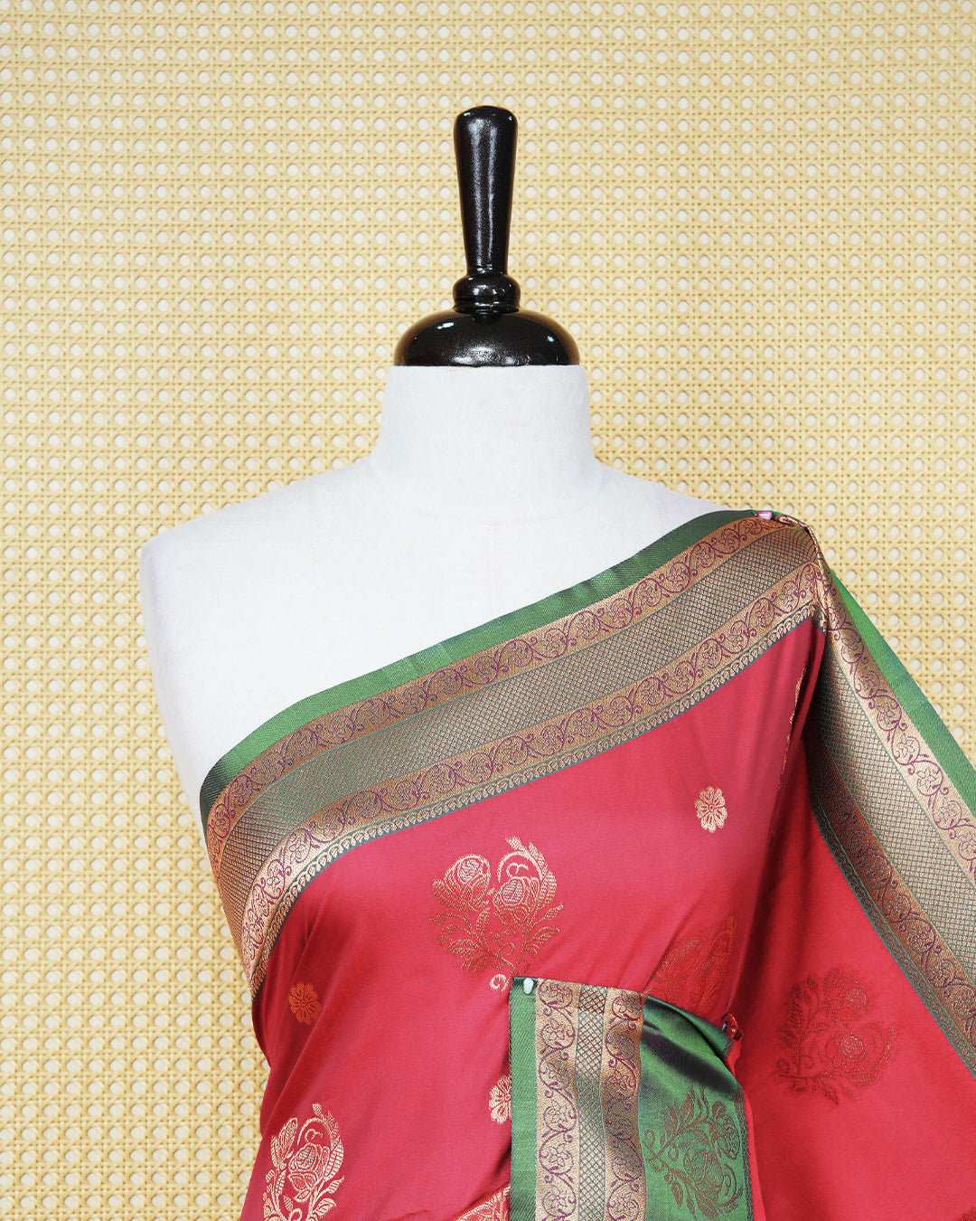 Red colour Mulberry silk saree featuring floral gold zari patterns on body, paired with contrast Green colour with traditional border, comes with matching blouse piece.