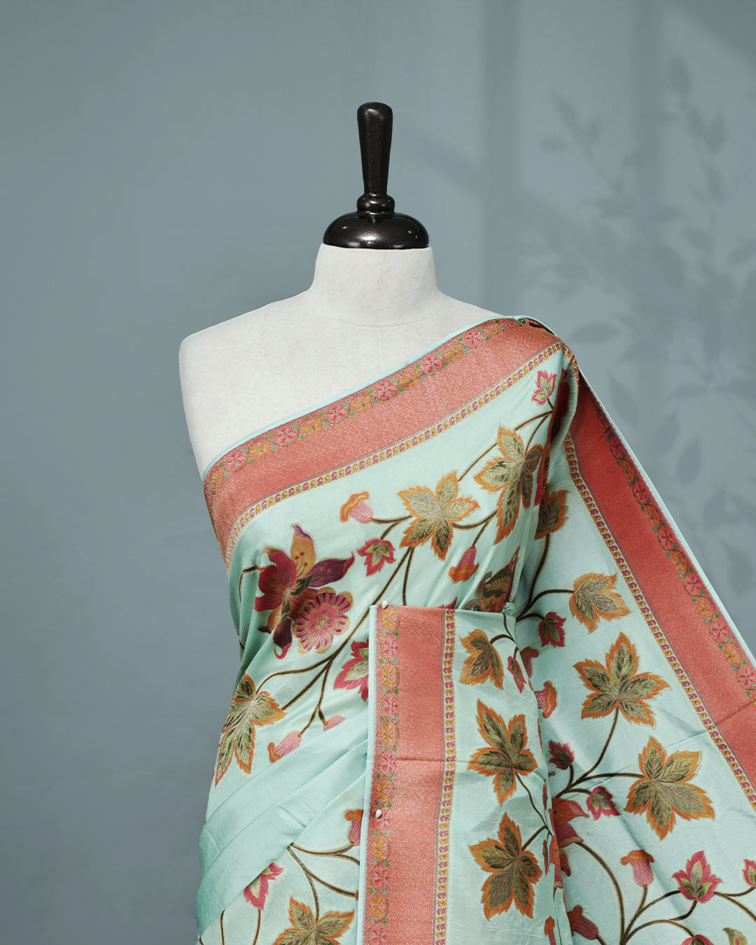 Ice Blue Colour Pashmina Saree featuring Plain body, complemented by Contrast Brick red colour with Floral pattern & gold zari on border and Pallu, comes with matching blouse piece.