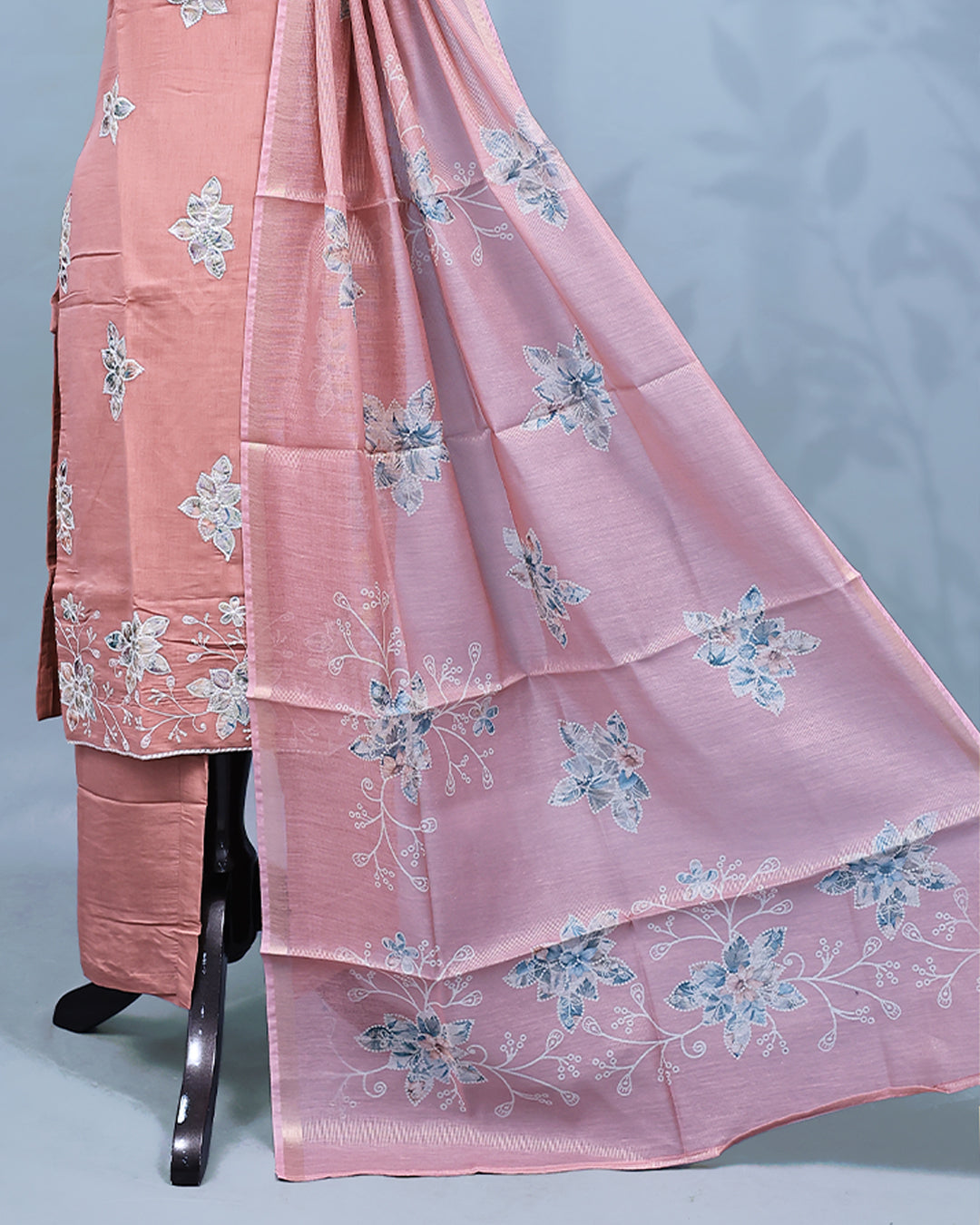 Pastel Peach colour Salwar set comes top with floral pattern on body, paired with matching bottom and dupatta.