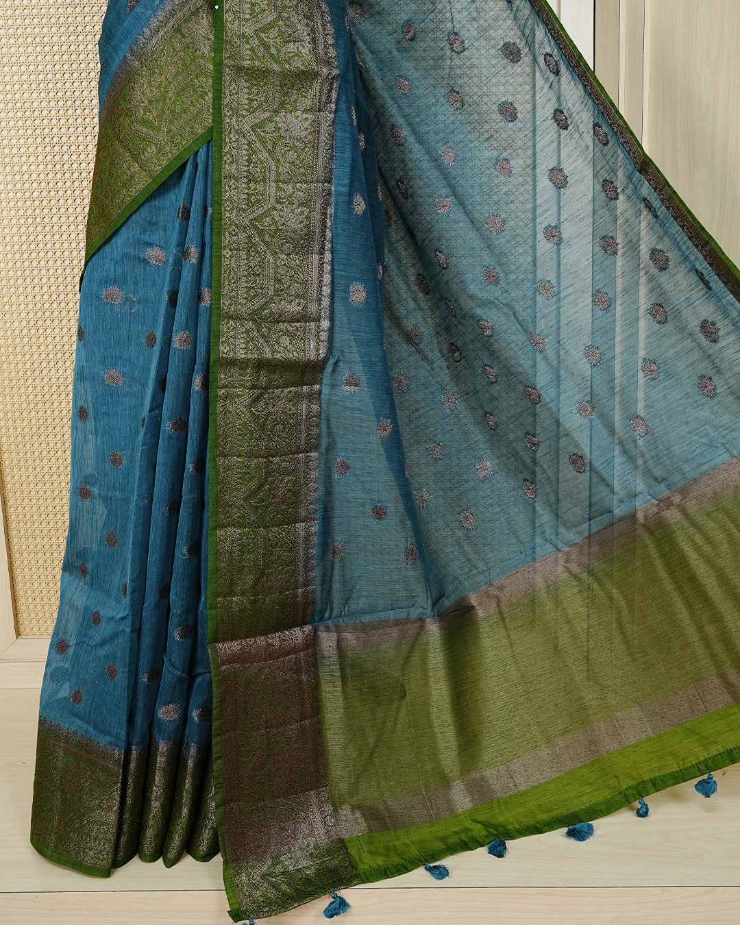 Teal blue colour semi linen saree thread motifs on body, contrast green colour gold zari border, rich pallu comes with matching blouse piece