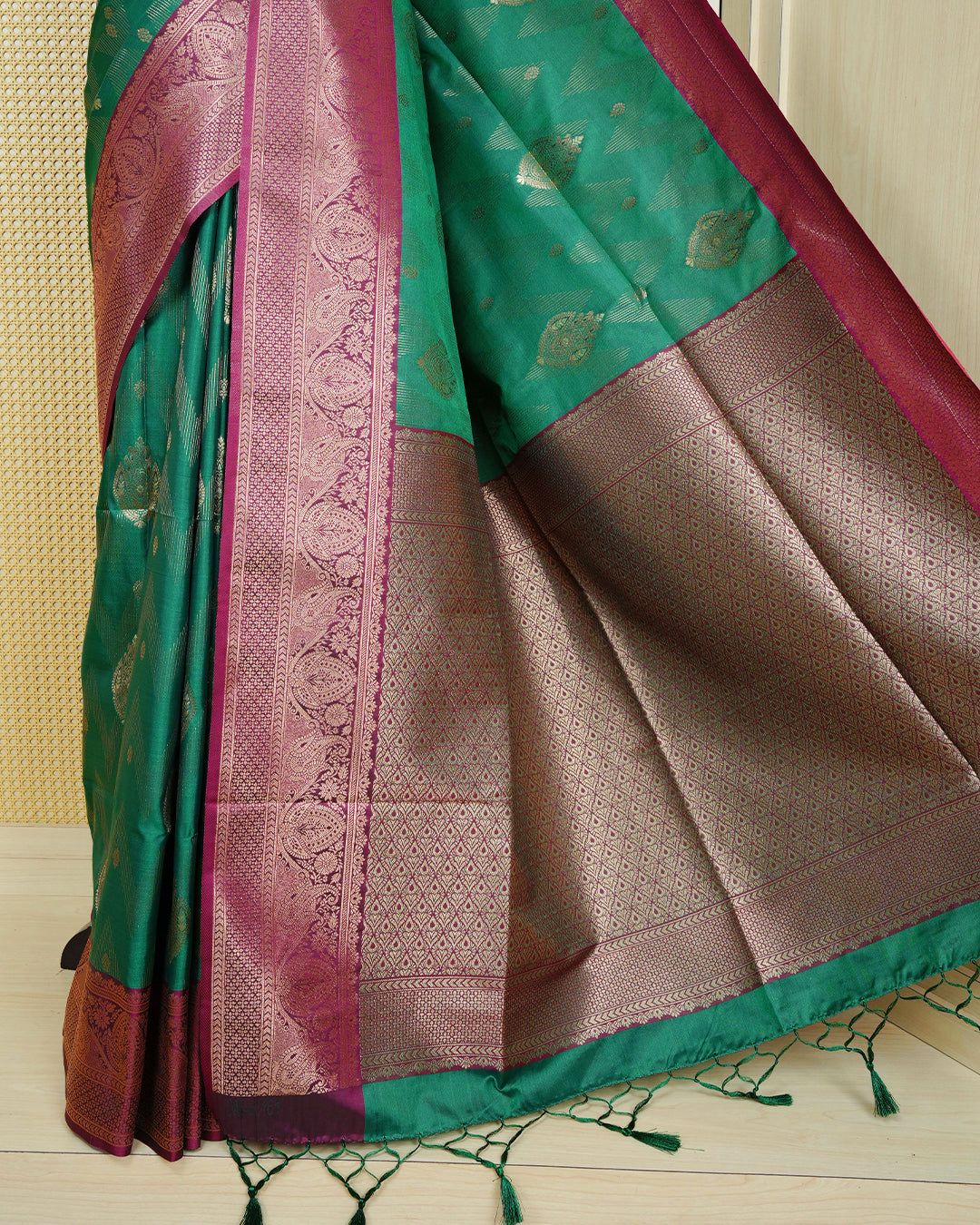 Green colour Mulberry silk saree featuring gold floral zari patterns on body, paired with contrast maroon colour with traditional border, comes with matching blouse piece.