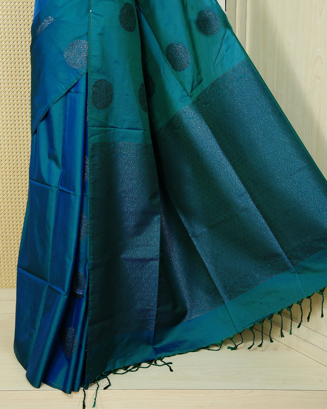 Peacock blue colour soft silk saree featuring antique zari motifs on body with contrast self colour pallu & paired with matching blouse piece.