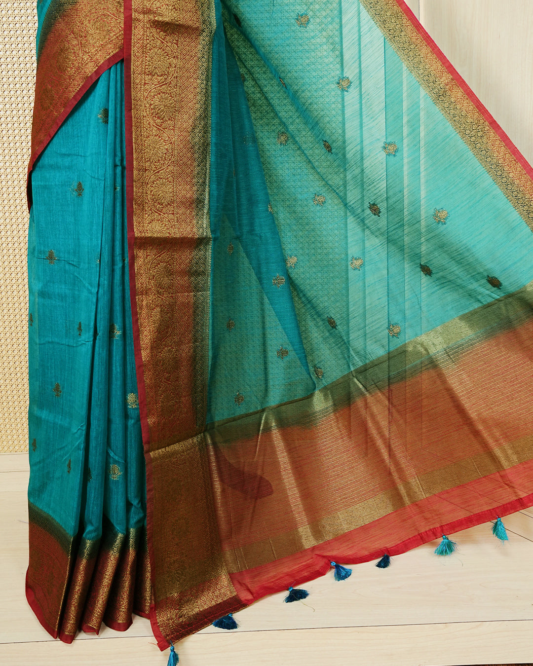 Teal blue colour semi linen saree thread motifs on body, contrast green colour gold zari border, rich pallu comes with matching blouse piece