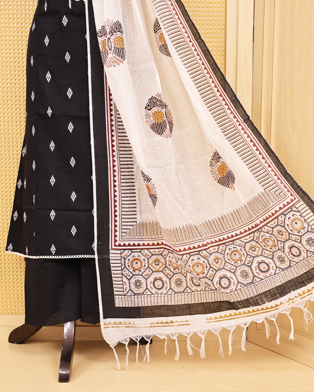 Black colour Cotton salwar material featuring Thread with mirror work on body, paired with matching bottom & dupatta.