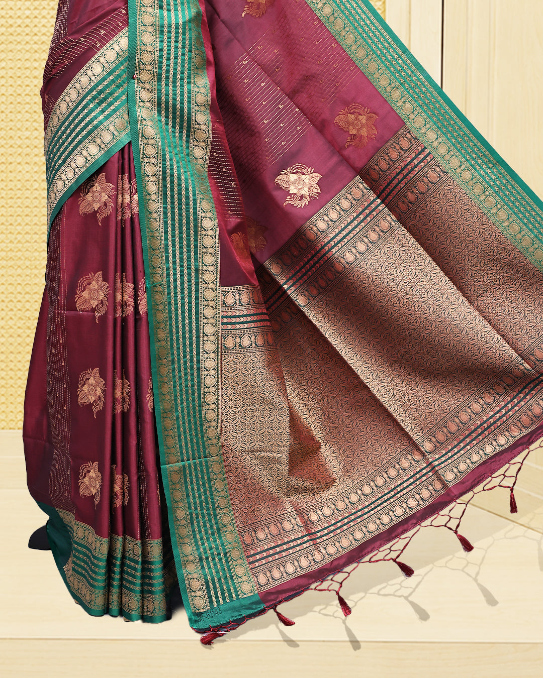 Maroon & gold double shade Mulberry silk saree featuring floral gold zari patterns on body, paired with contrast green colour with traditional border, comes with matching blouse piece.