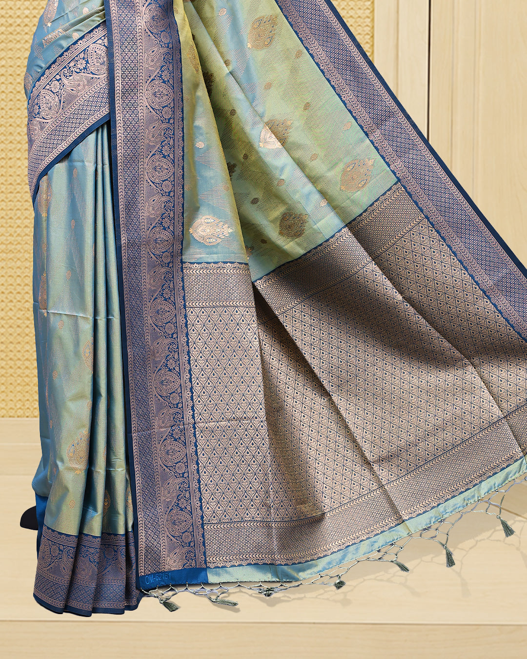 Olive green & gold double shade Mulberry silk saree featuring floral gold zari patterns on body, paired with contrast teal colour with traditional border, comes with matching blouse piece.