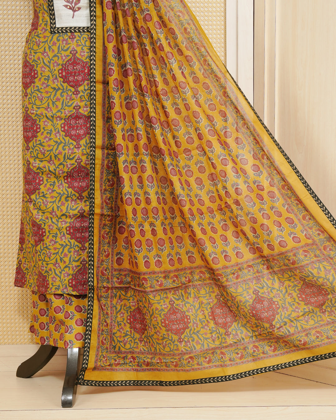 Dark yellow colour salwar material featuring Floral print and mirror work with elegant border, paired with matching bottom and an elegant dupatta.