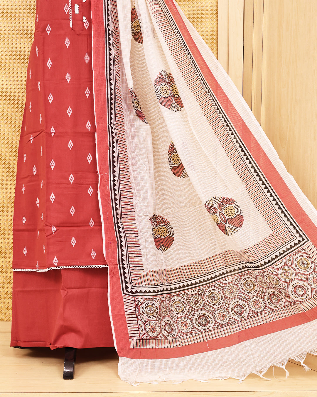 Brick red colour Cotton salwar material featuring Thread with mirror work on body, paired with matching bottom & dupatta.