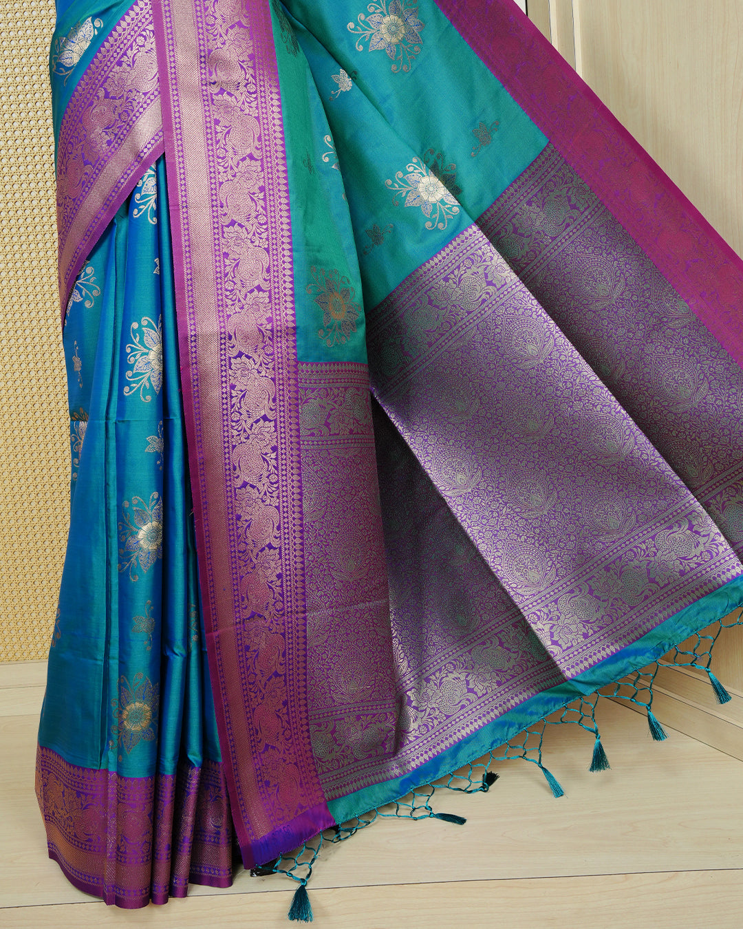 Peacock green Mulberry silk saree featuring gold floral zari patterns on body, paired with contrast wine colour with traditional border, comes with matching blouse piece.