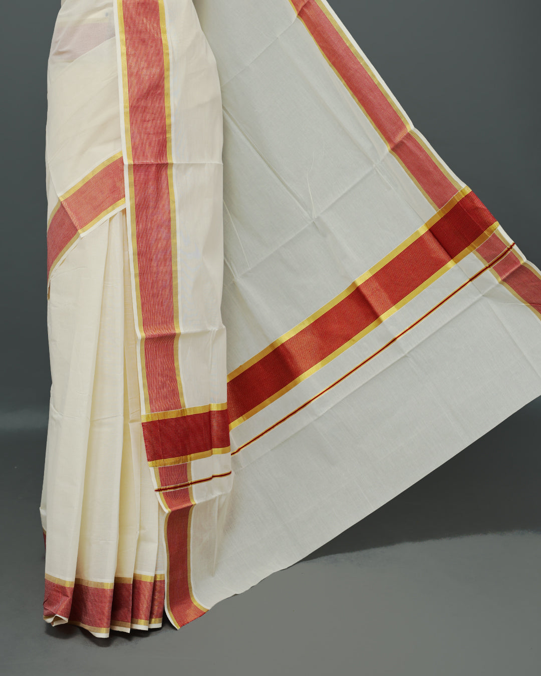 Cream colour Kerala saree Featuring an Elegant plain body, complemented by a classic gold & Red zari border, matching blouse piece.