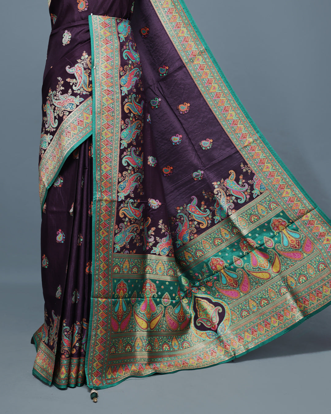 Purple Colour Pashmina Saree featuring Mango motifs on body, complemented by Contrast Green colour with Floral pattern & gold zari on border and Pallu, comes with matching blouse piece.