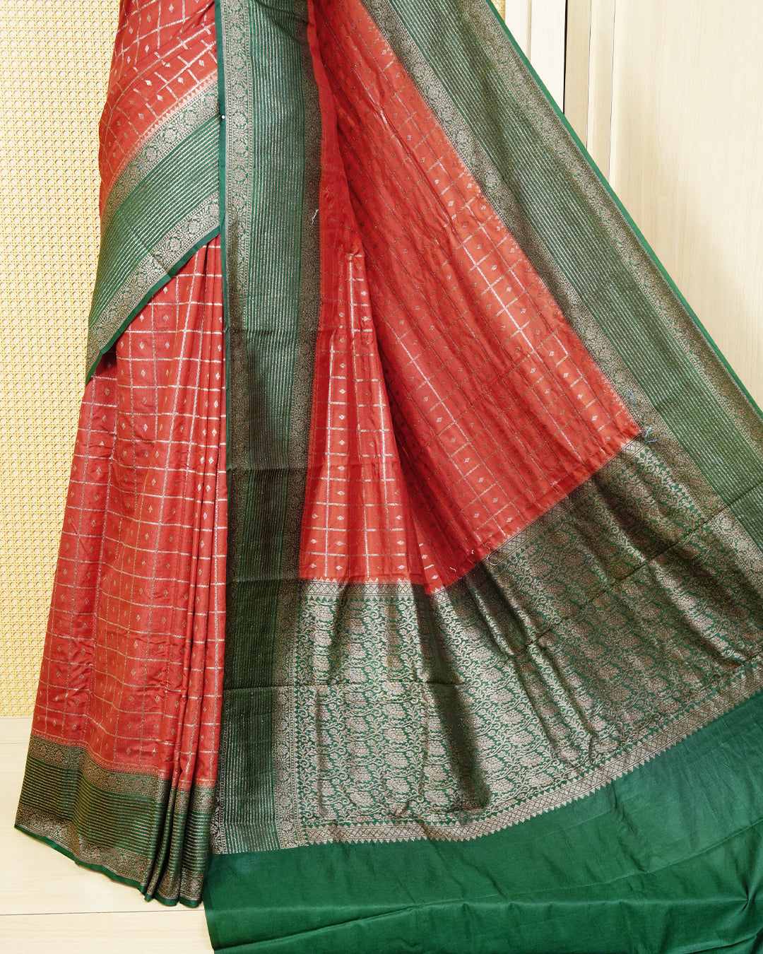 Burnt orange Colour Semi georgette Saree having zari check with buttas pattern on body, contrast dark green colour floral designed border, Rich Pallu comes with Matching Blouse piece.