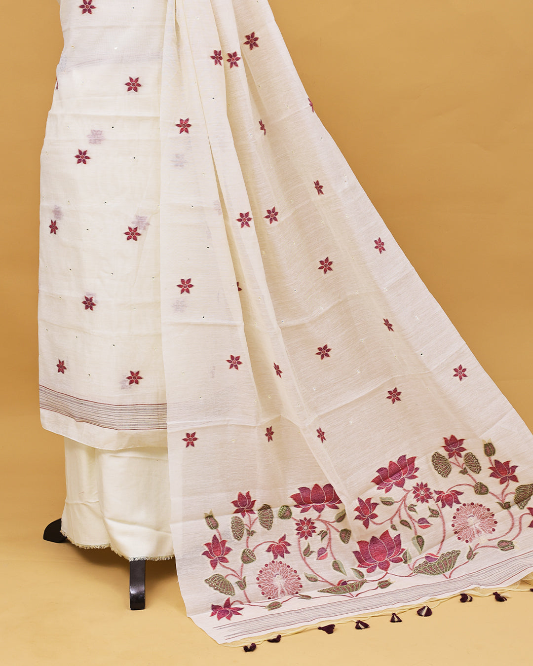 Off White colour Salwar material with Floral buttas With Mirror work on body, matching bottom & Dupatta.