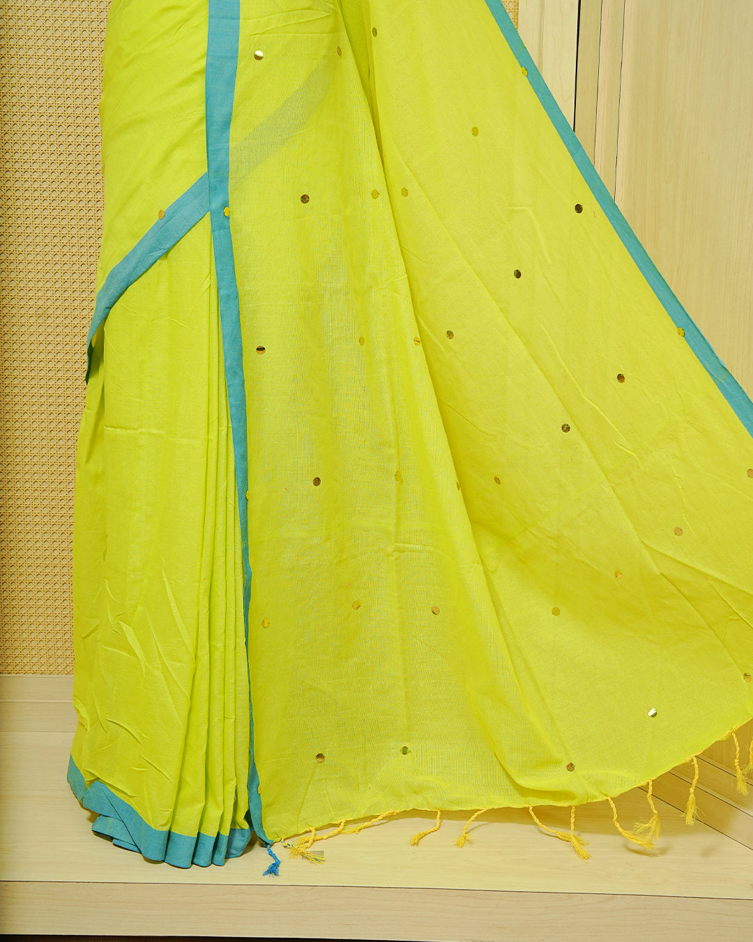 Fluorescence yellow colour Mul cotton saree featuring Gold Sequins, complemented by Contrast Aqua simple Border & tassels.