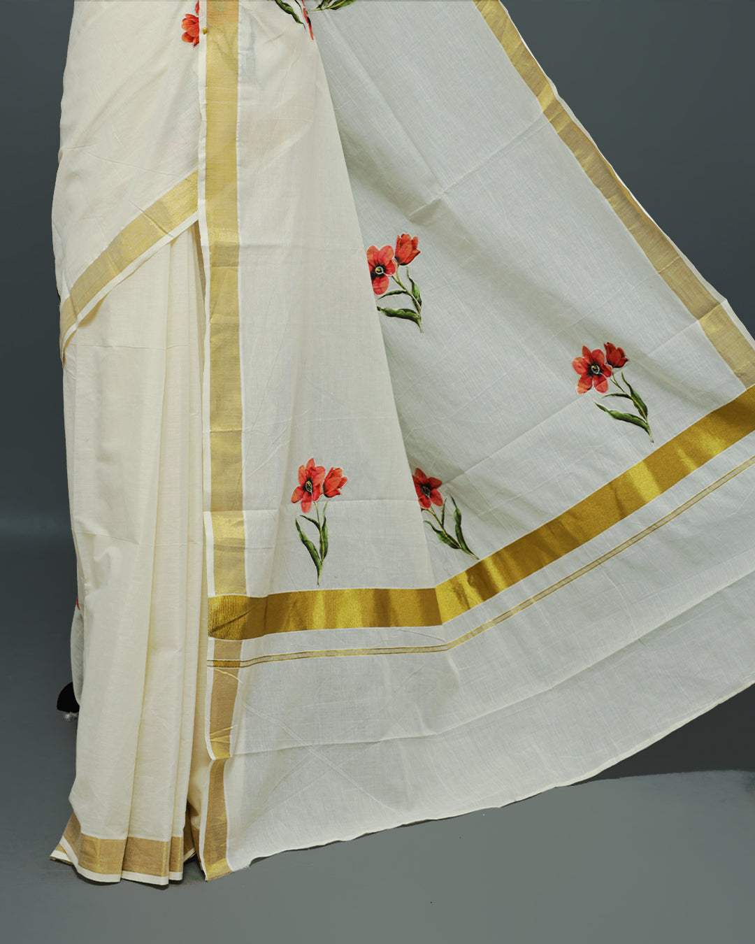Cream colour Cotton kerala saree featuring floral Print with thread work on the body, complemented by a gold zari Border, paired with a matching blouse piece.